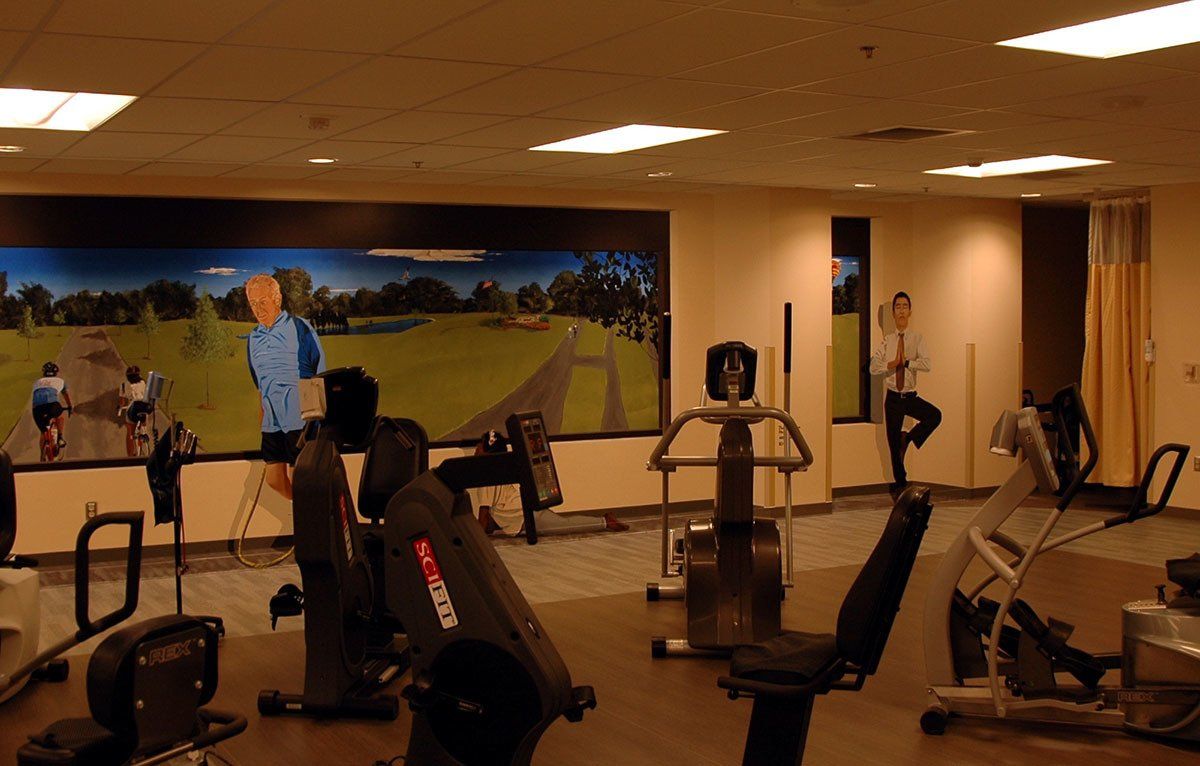 A gym with a mural of a man running on the wall