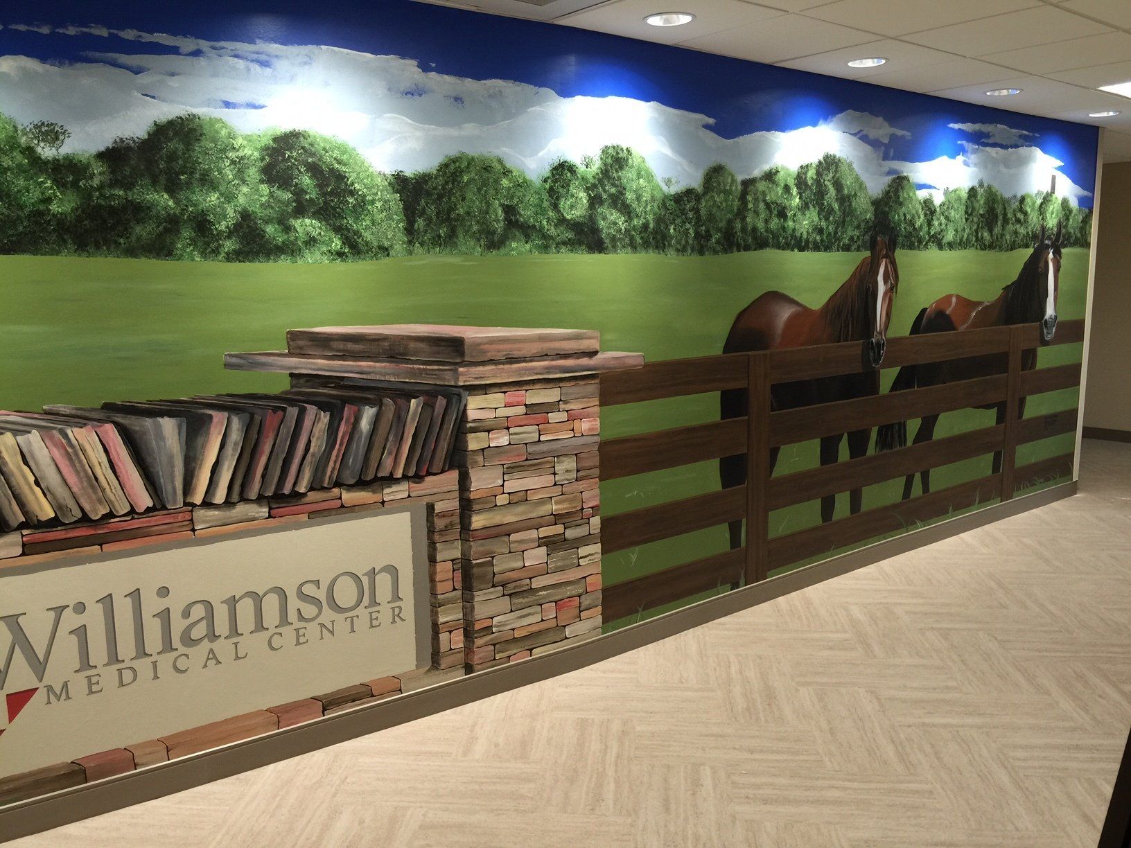 A hallway with a picture of horses and a sign that says williamson medical center