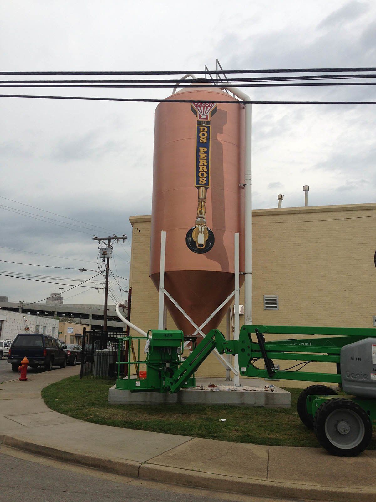 A large copper silo with a sign on it that says