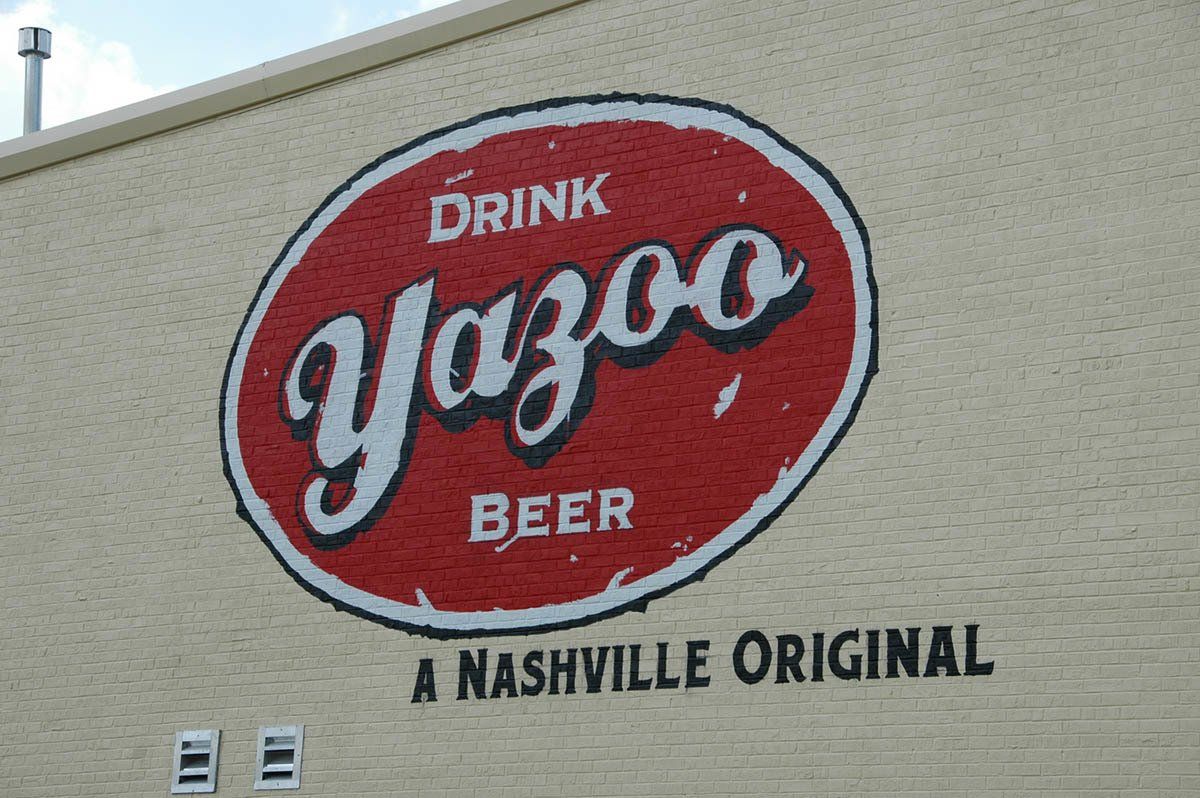A sign on a building that says drink yazoo beer