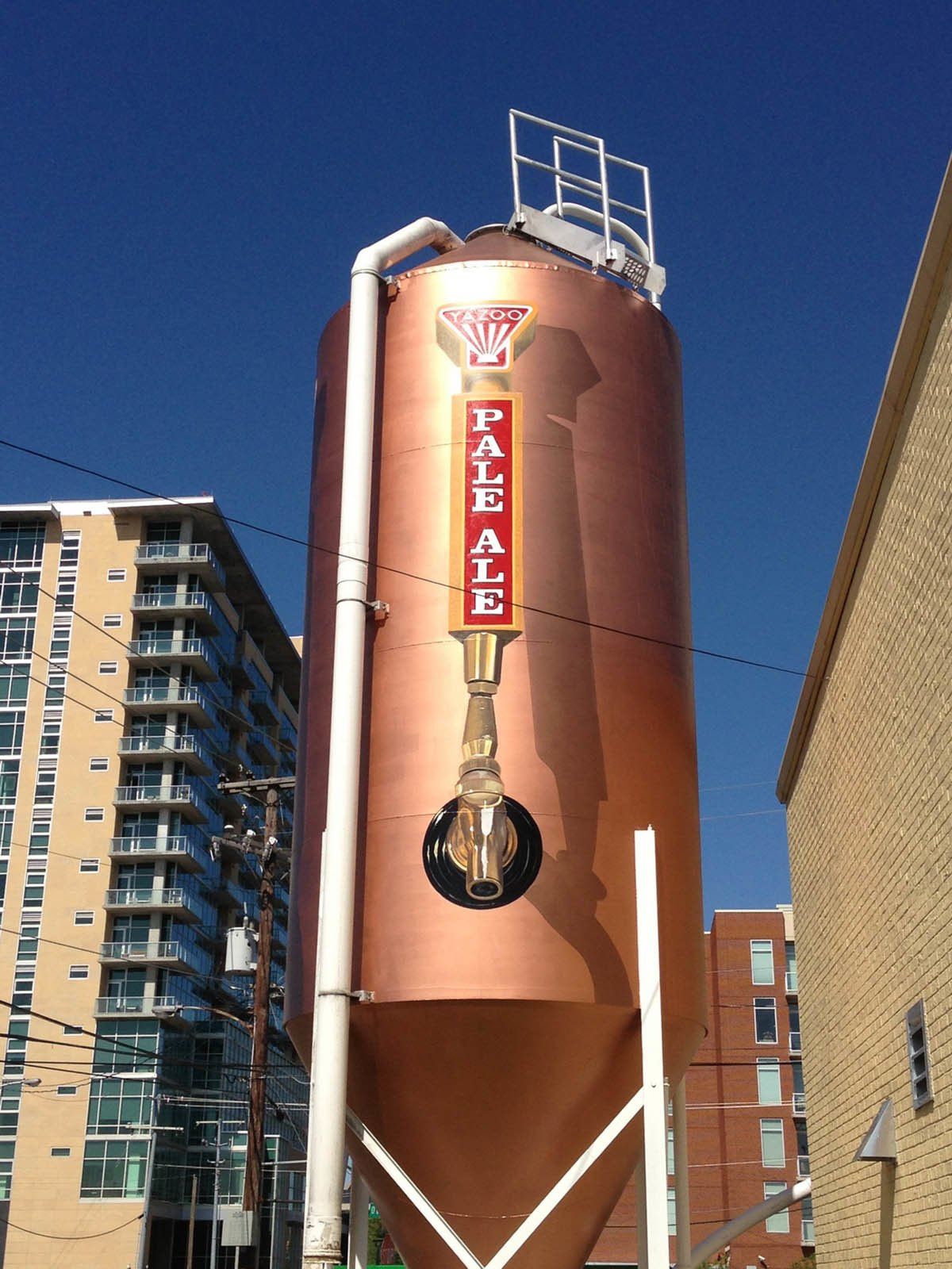 A large copper silo that says pale ale on it
