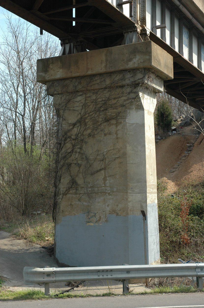 A bridge with a concrete pillar underneath it