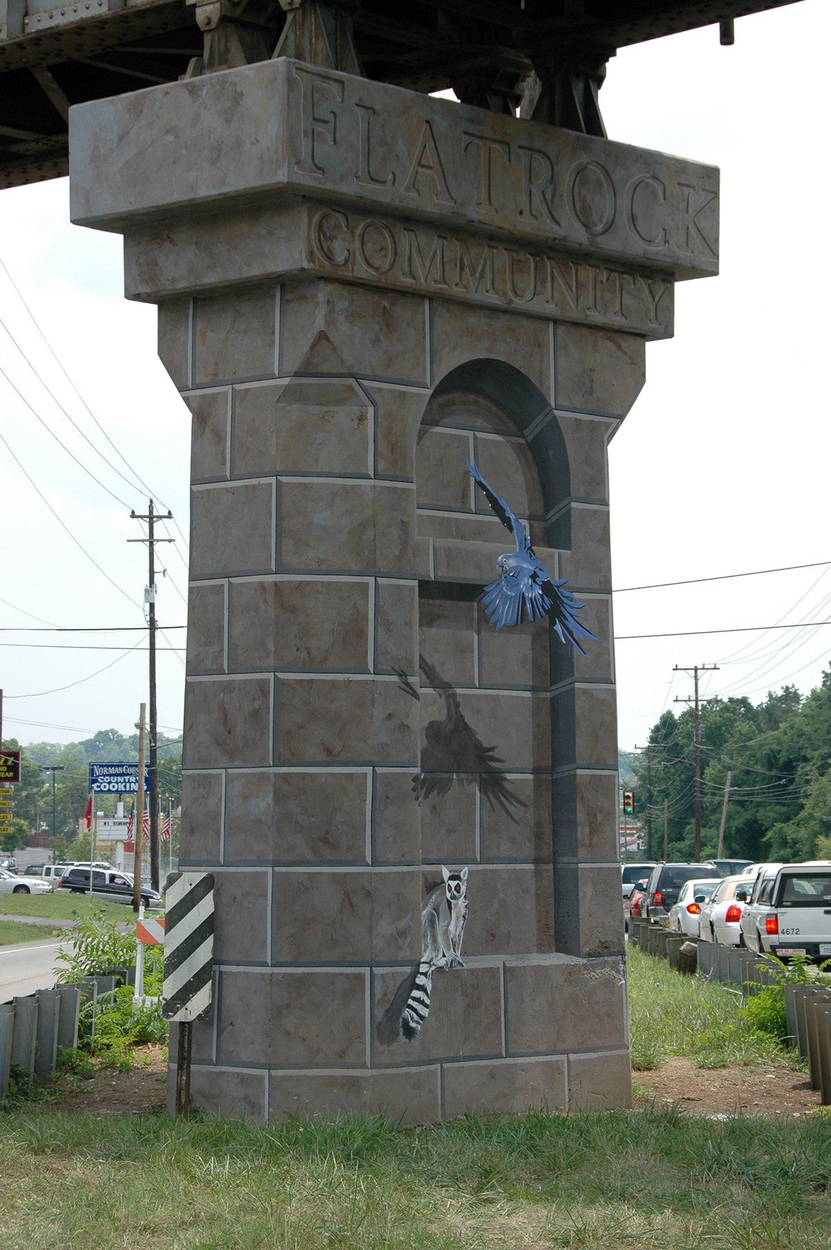 A large brick pillar with the word flat rock on it