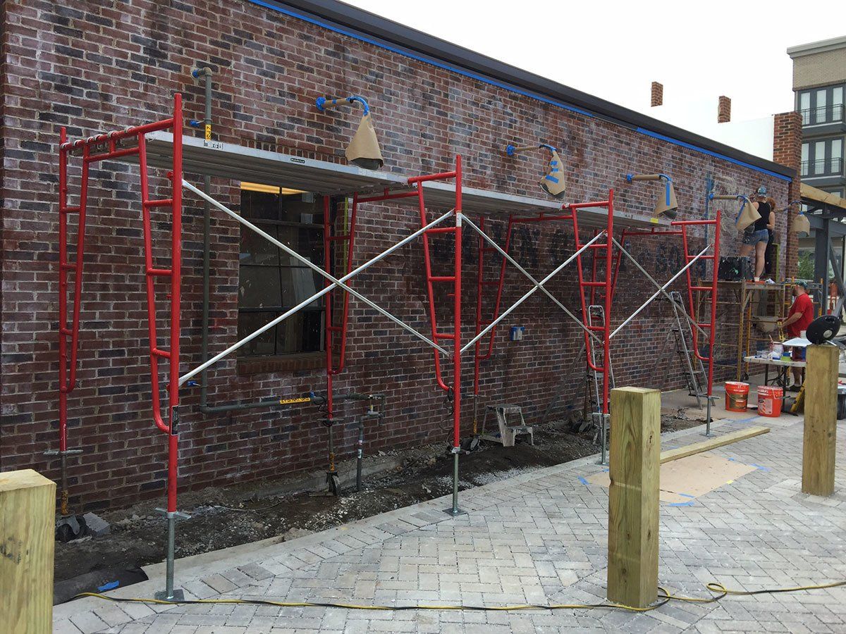 A brick building with scaffolding on the side of it