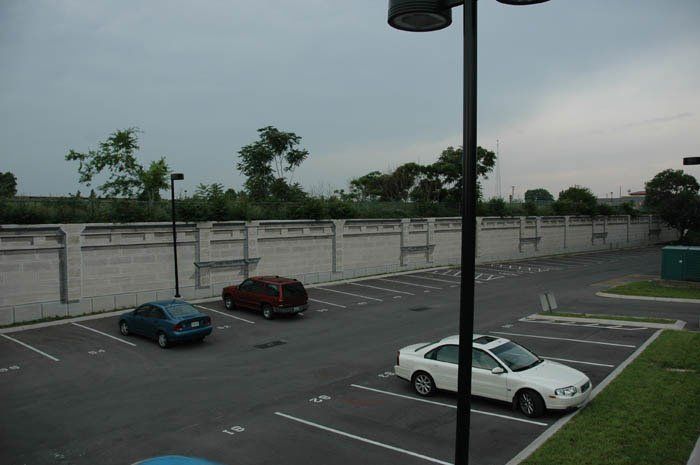 A white car is parked in a parking lot