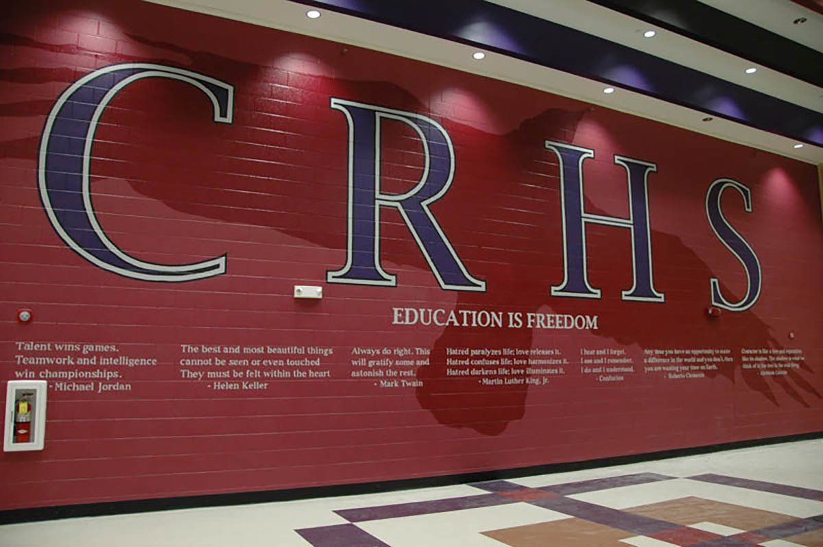 A red wall with the word crhs on it