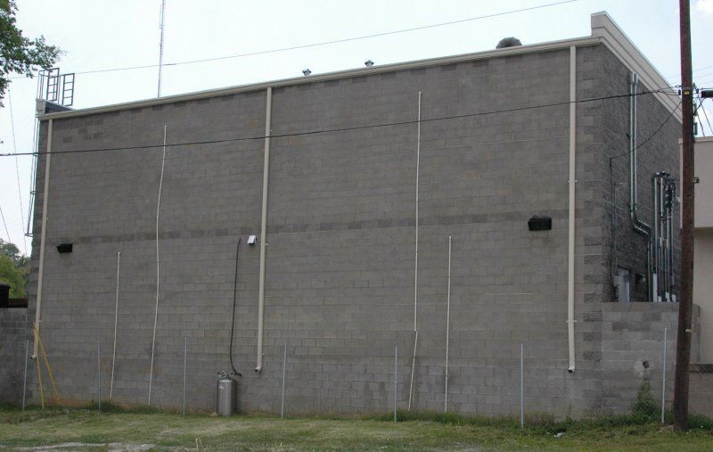 A large brick building with a fence in front of it