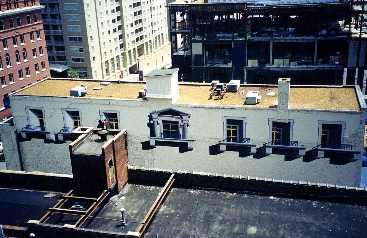 A rooftop view of a building with a lot of windows