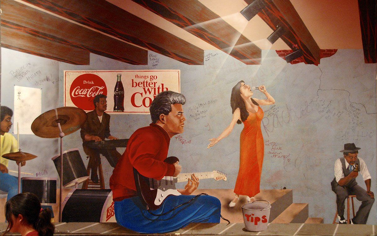 A painting of a man playing a guitar in front of a coca cola sign