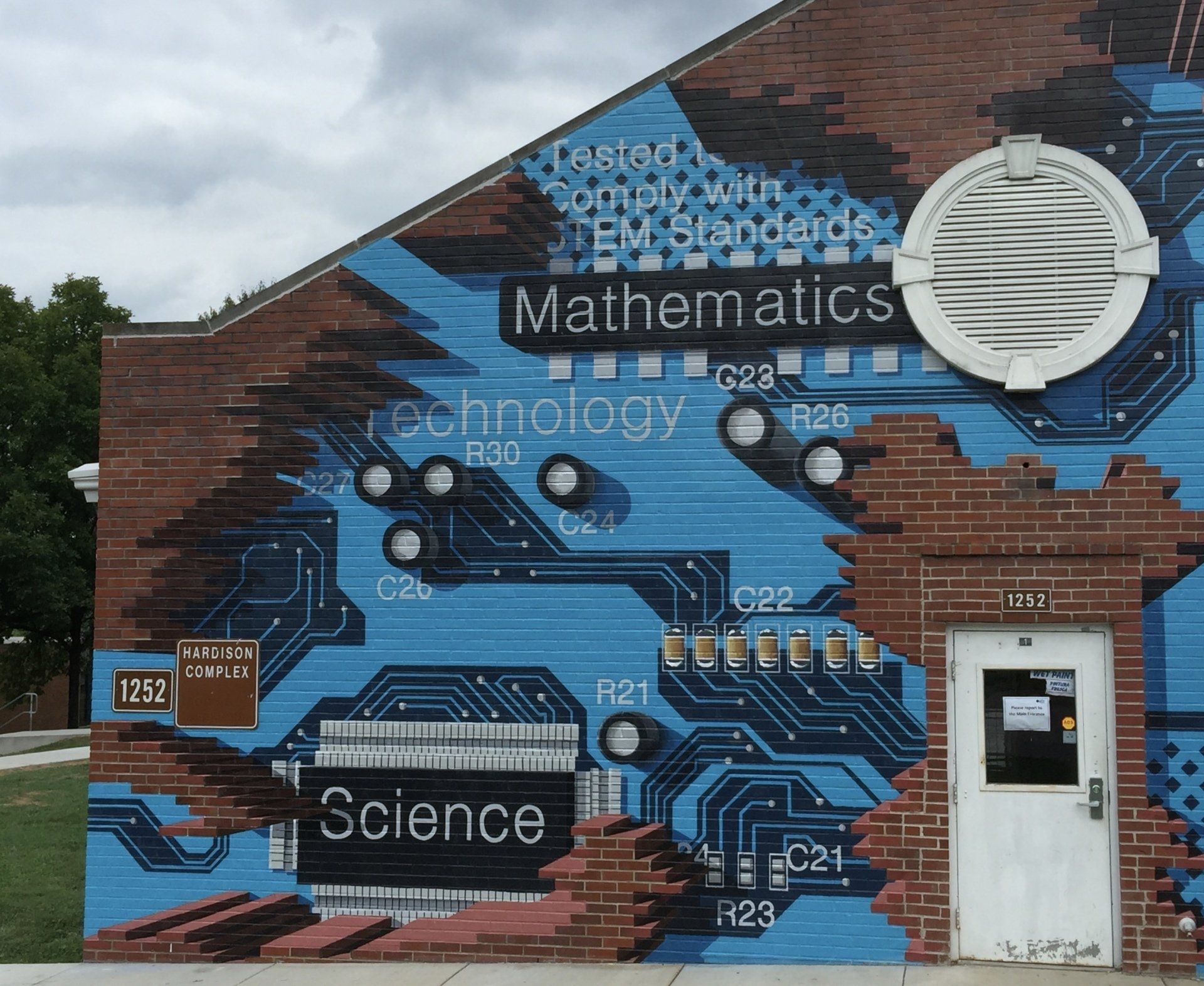 A mural on the side of a building says mathematics technology and science