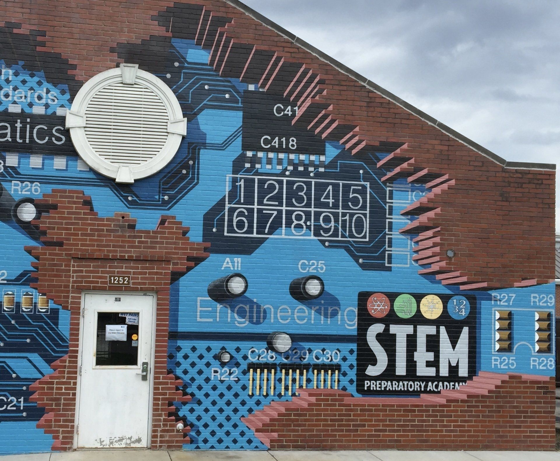 A building with a mural on it that says stem