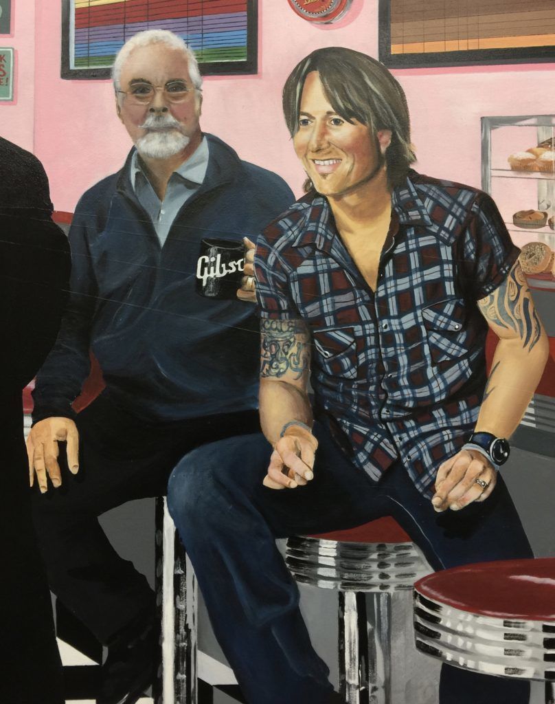 A man holding a cup that says gibson on it