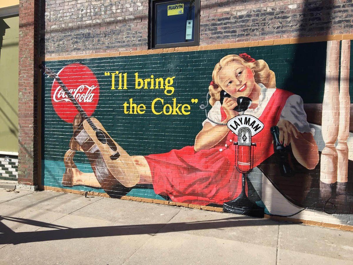 A mural of a woman talking on a phone says 