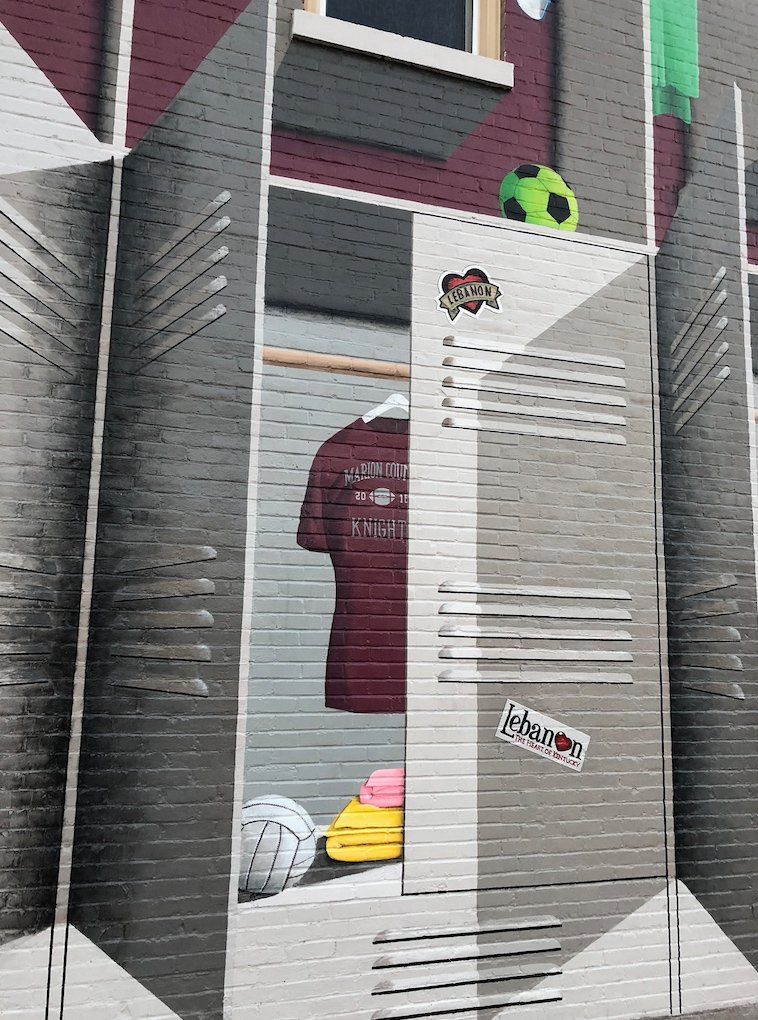 A locker with a shirt and a soccer ball in it