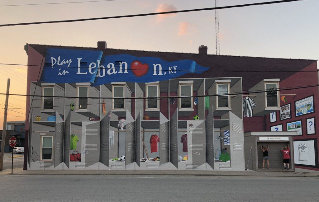 A large mural on the side of a building says play in lebanon n.y.