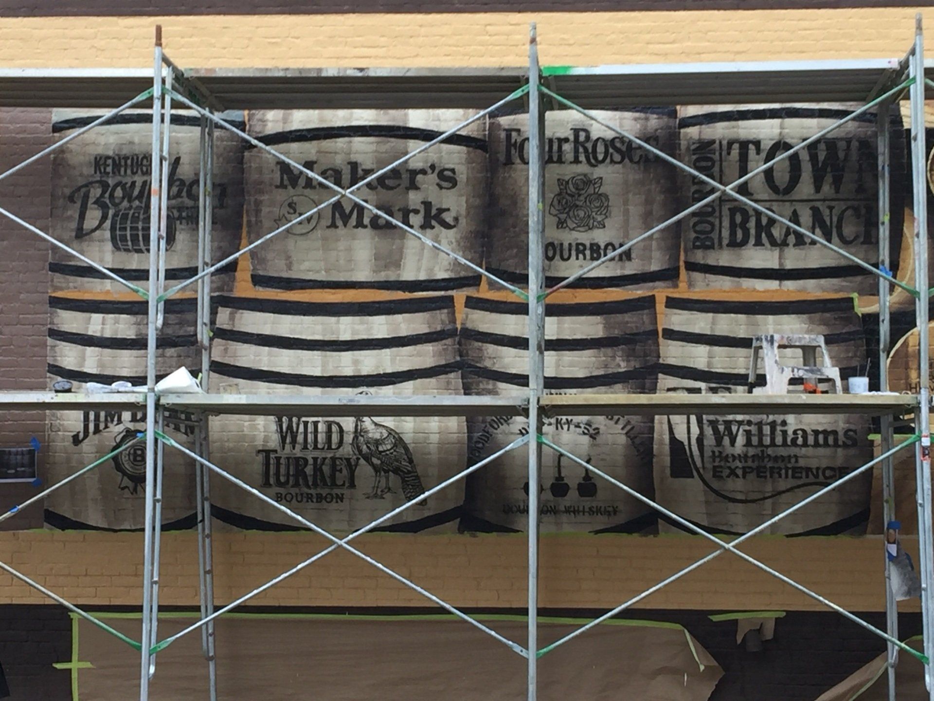 A row of barrels with maker 's mark and wild turkey written on them