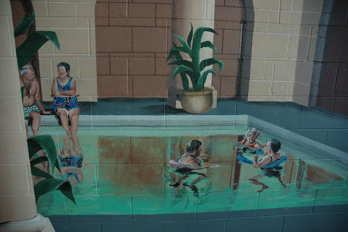 A group of people are sitting in a swimming pool.