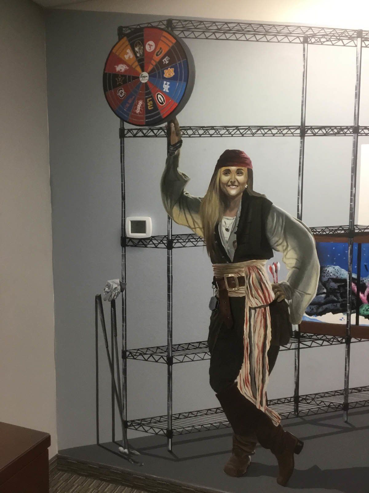 A cardboard cutout of a pirate holding a wheel of fortune