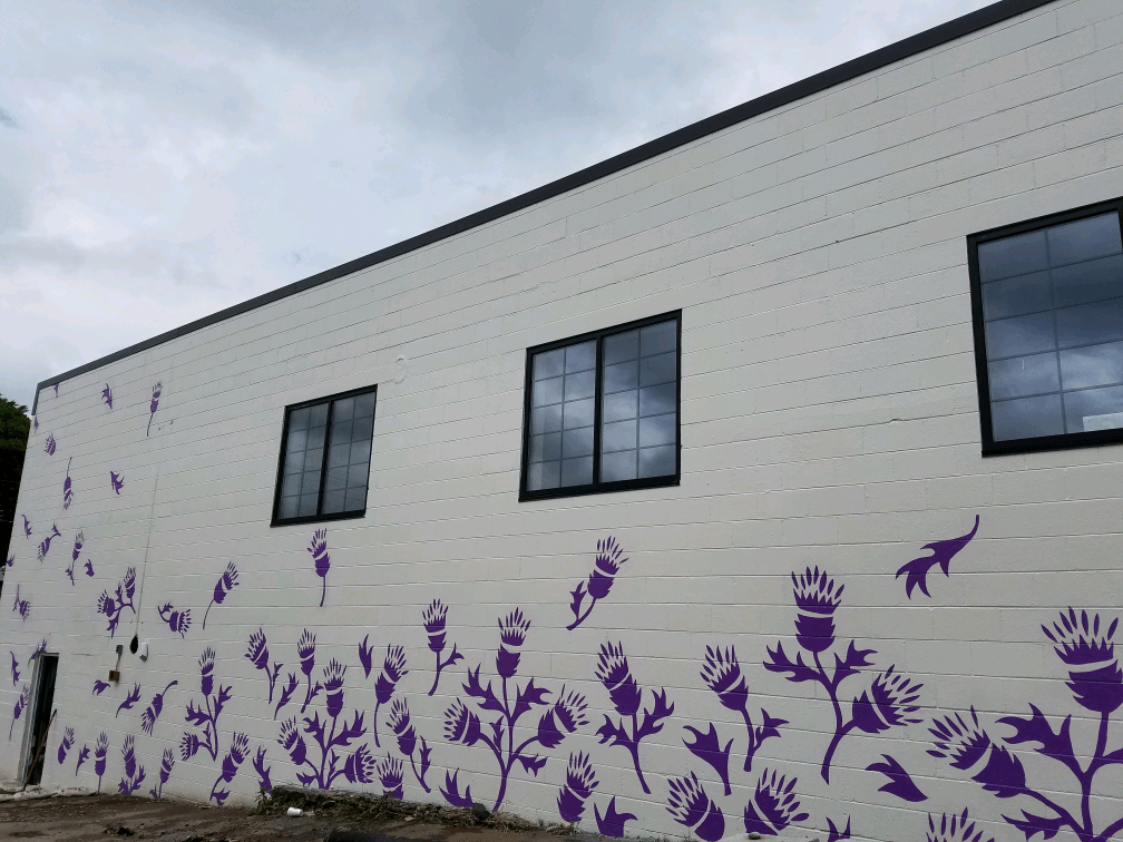 A white building with purple flowers painted on it