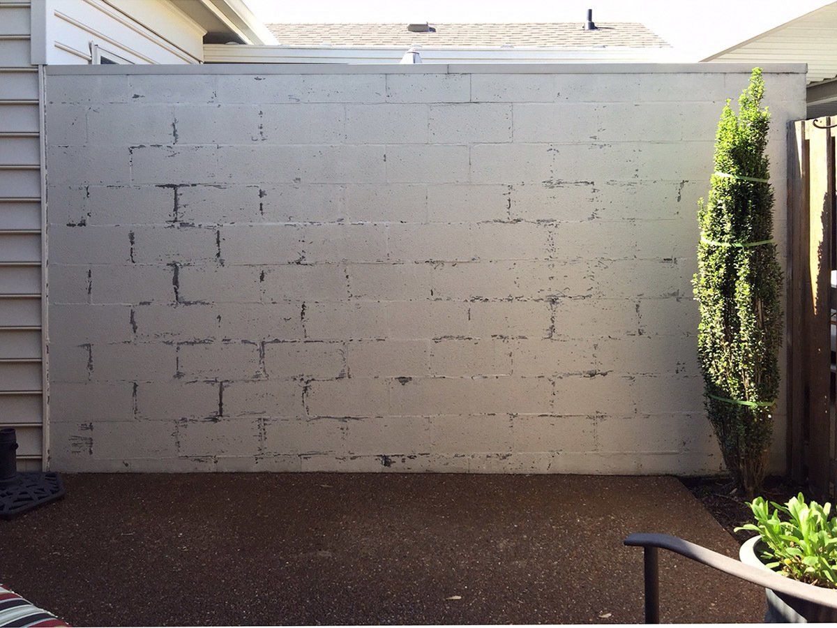 A white brick wall with the letter i on it