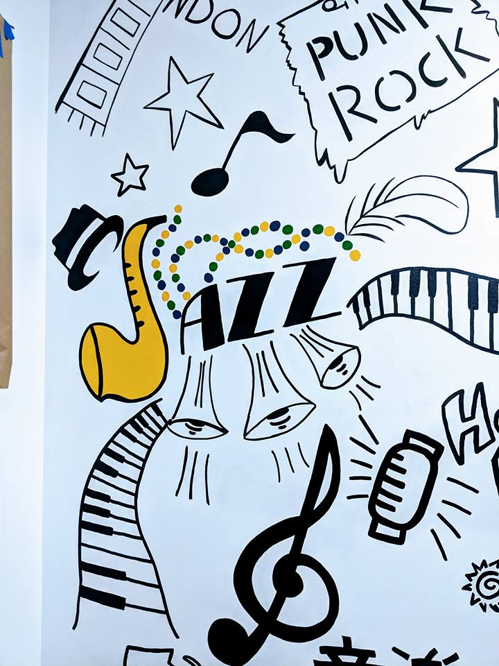 A drawing on a wall that says punk rock jazz