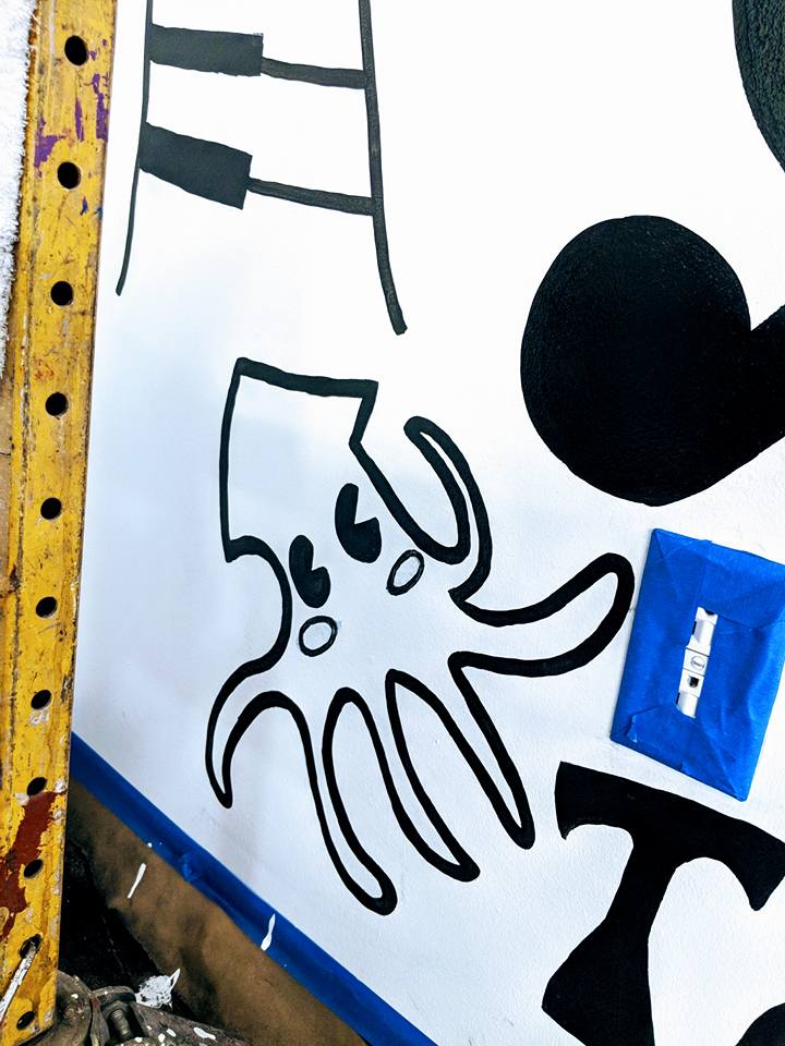 A drawing of an octopus is on a white board