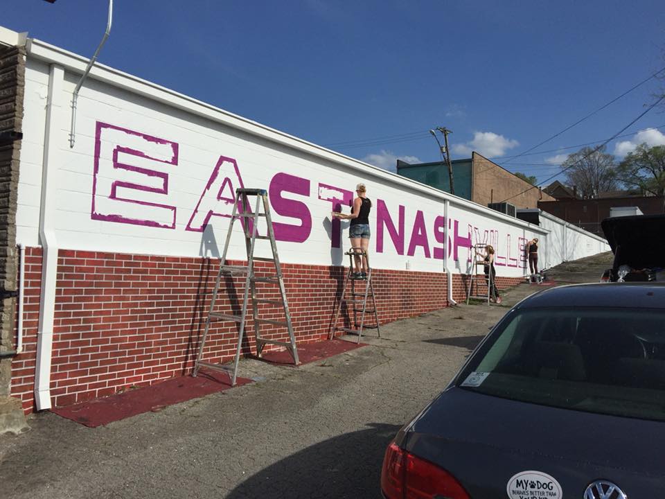 A brick wall with the word east nashville painted on it