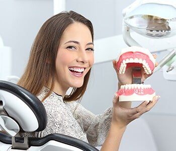 Dentist Patient Smiling with a Plastic Denture — Partial Denture in Westlake, OH Dentist Patient Smiling with a Plastic Denture — Partial Denture in Westlake, OH