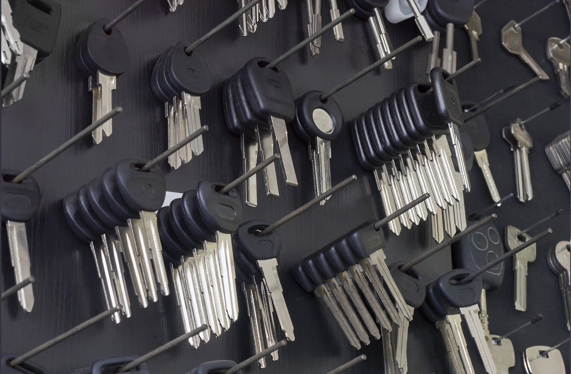 Keys hanging on a display board, various sizes and shapes.