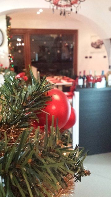 ristorante con albero di Natale e addobbi sui tavoli