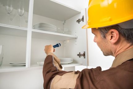 Pest Control Worker Checking Shelf - Pest control in Lafayette, NJ