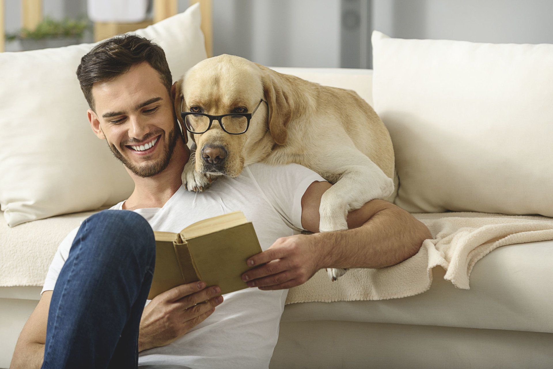 handsome guy holding book while smart pet read it