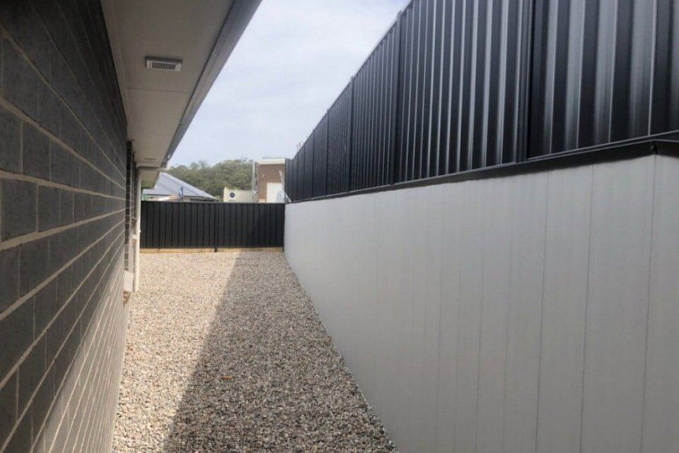 Concrete Block Wall and Pavement Sidewalk — Landscaping and Excavation Services in Cameron Park, NSW