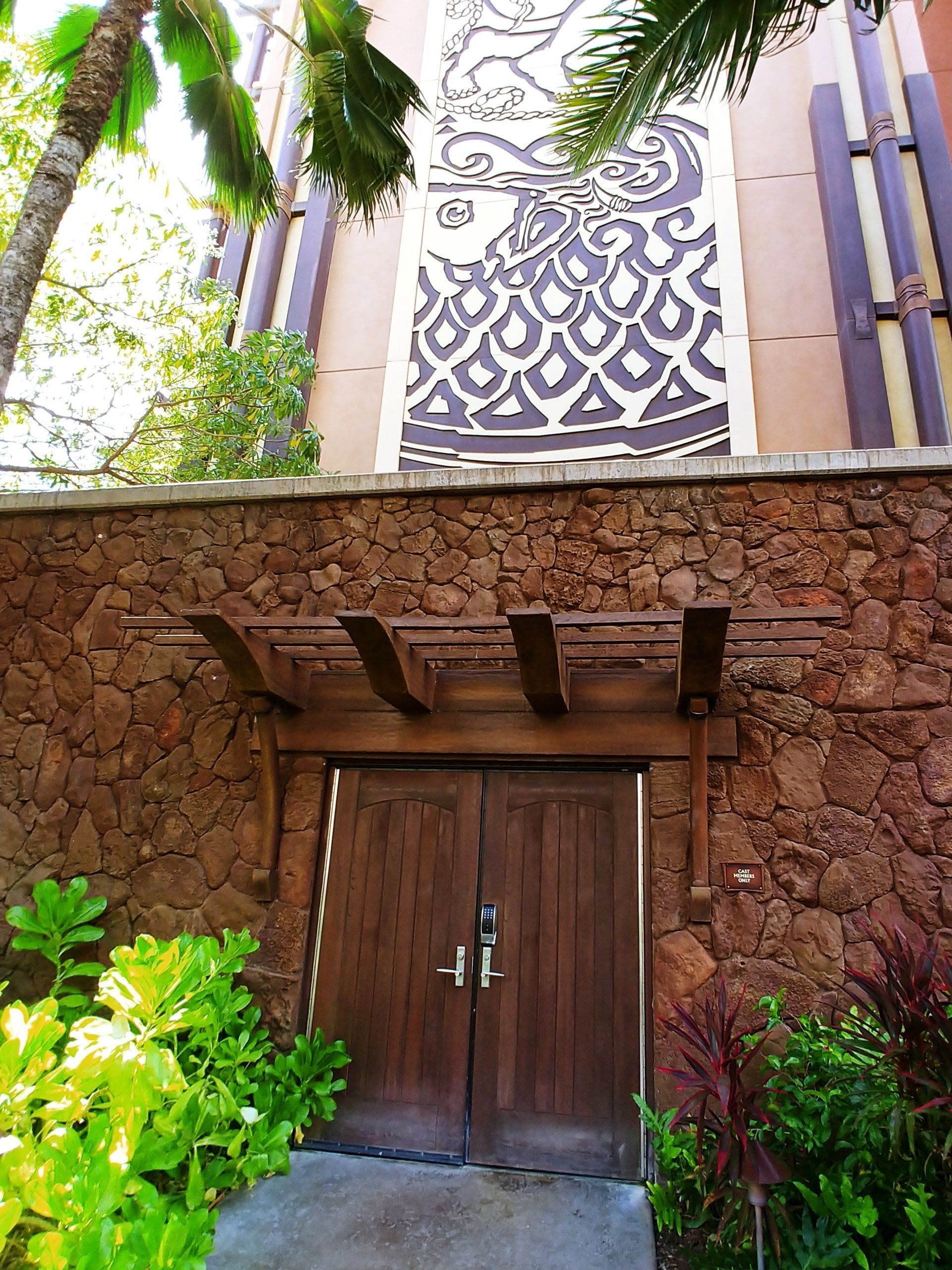 View of a building and a wall with moss rock exterior