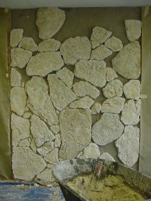 installation of stone onto the wall in progress