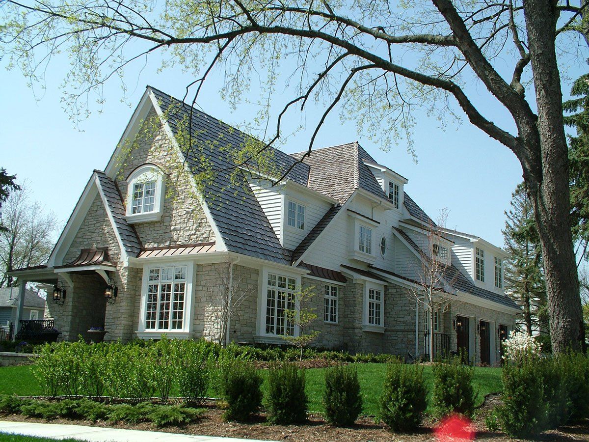 A large house with a blue roof and a lot of windows