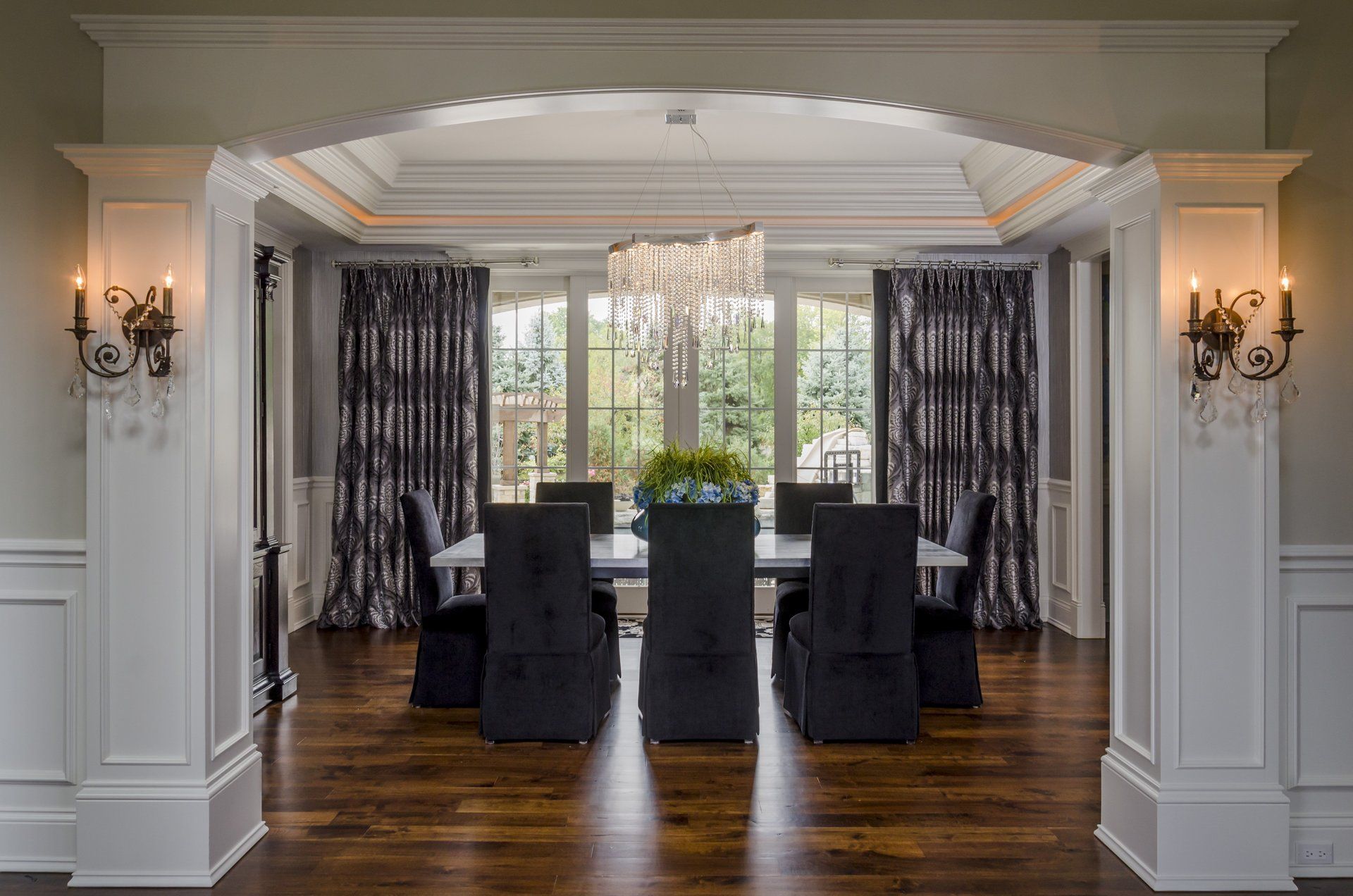 A dining room with a table and chairs and a chandelier.