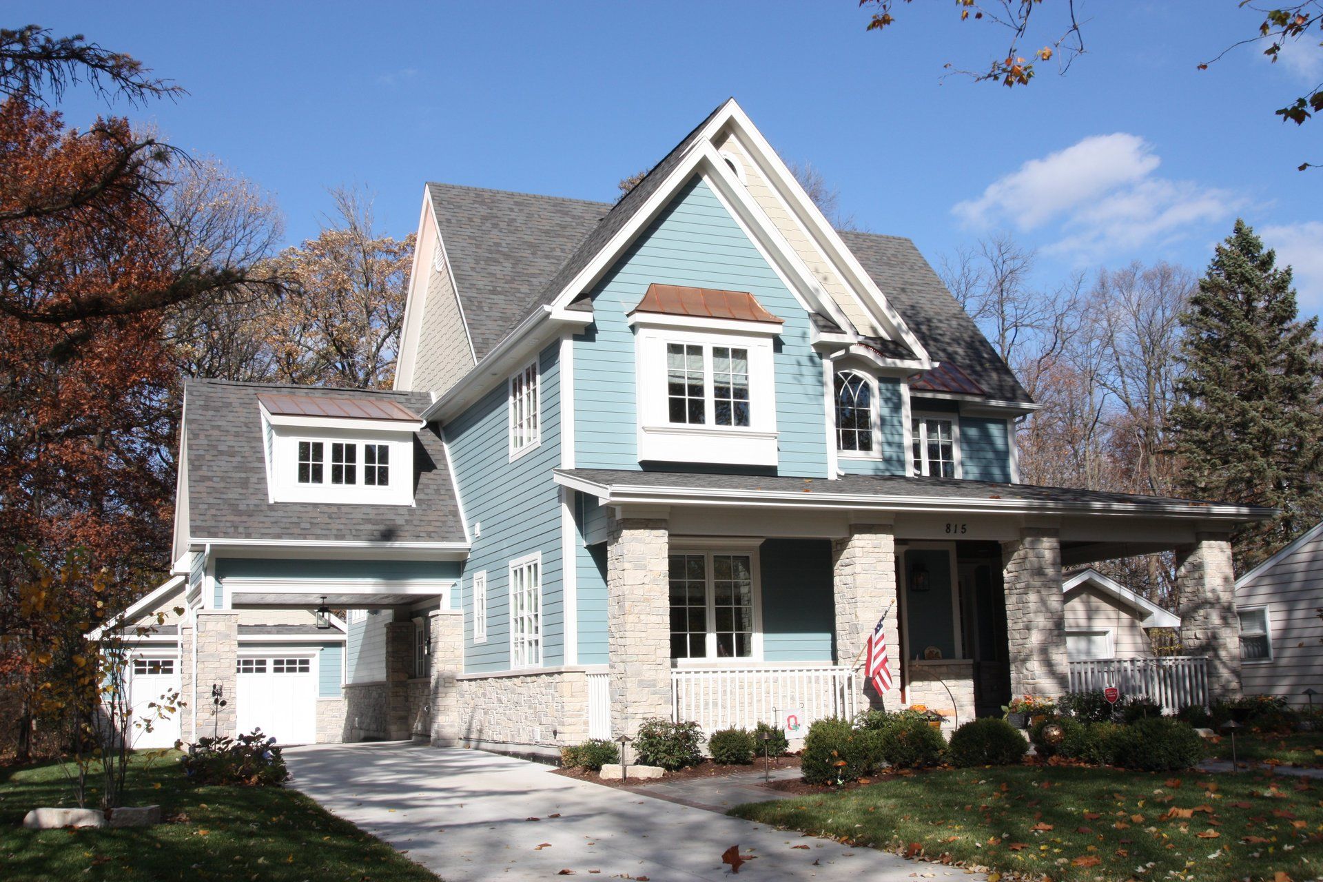 A blue and white house with a gray roof