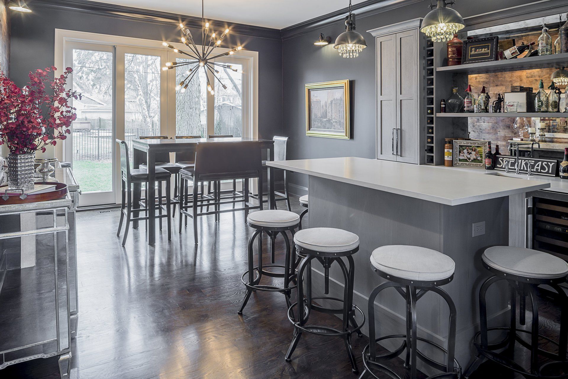 There is a large island in the middle of the room with stools around it.