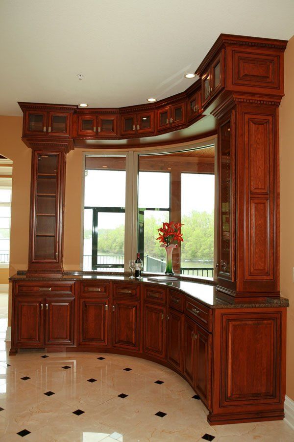 A kitchen with curved cabinets and a large window