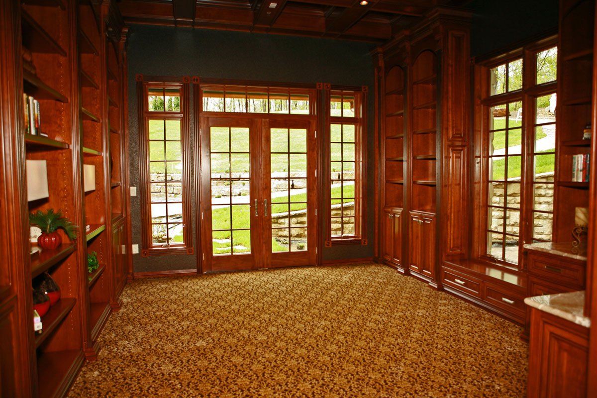 A room with a lot of windows and shelves