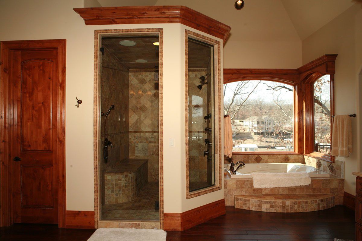 A bathroom with a bathtub and a walk in shower