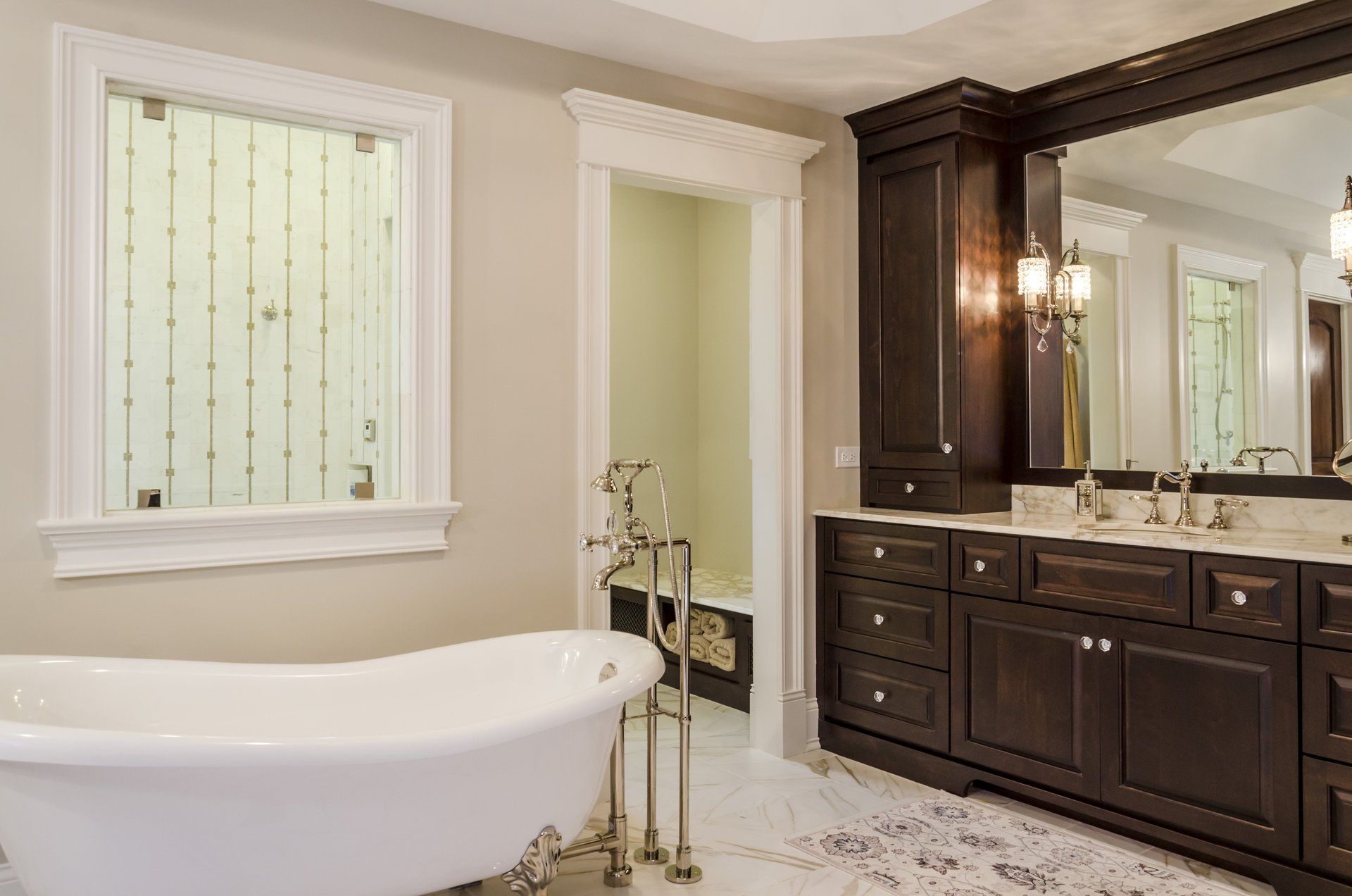 A bathroom with a tub , sink , mirror and window.