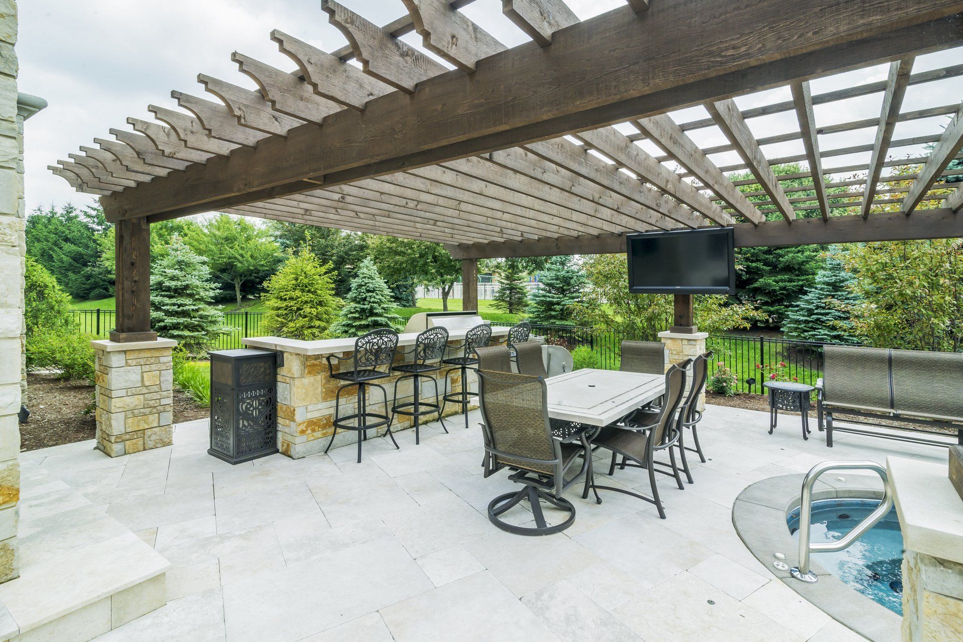 A patio with a table and chairs under a pergola.