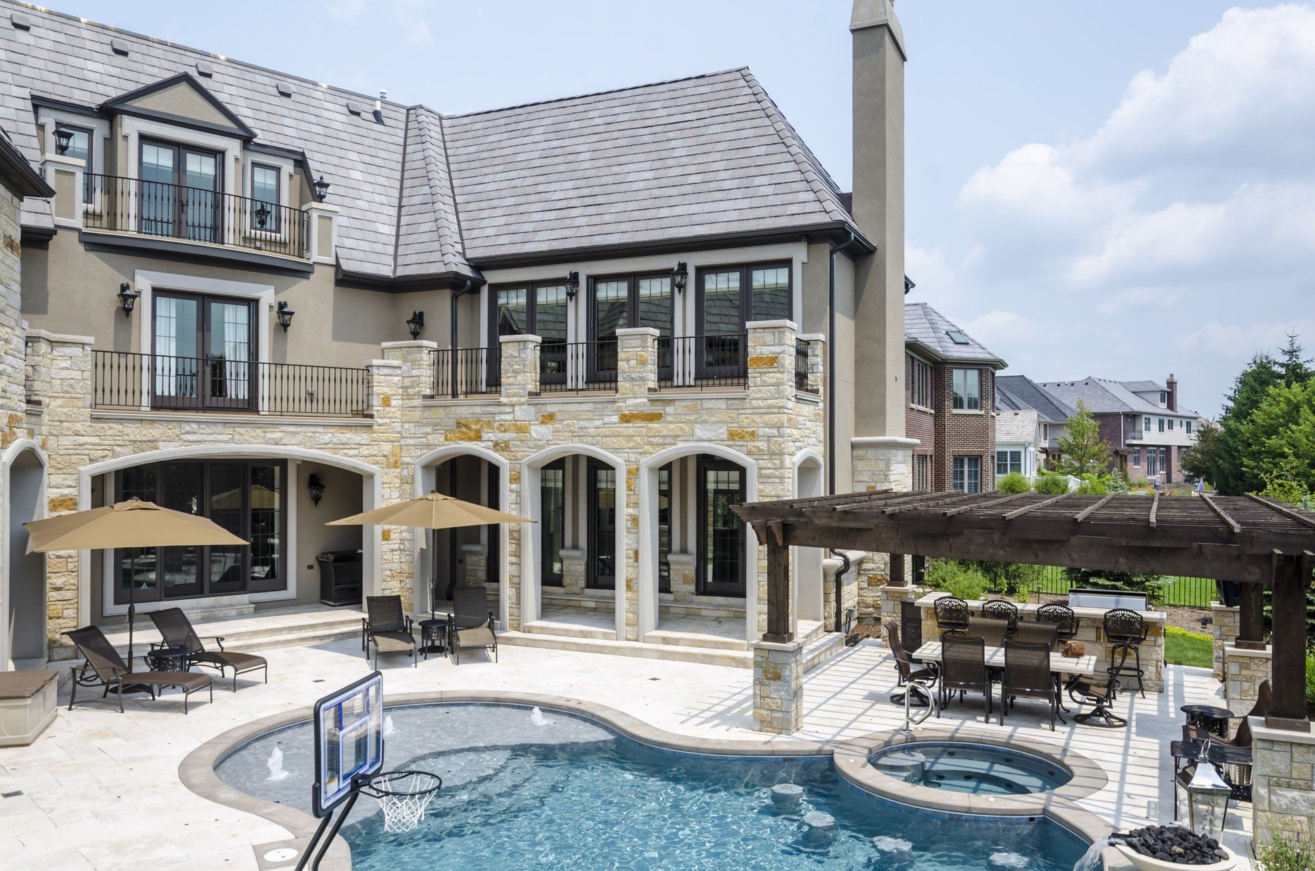 A large house with a large swimming pool in front of it.
