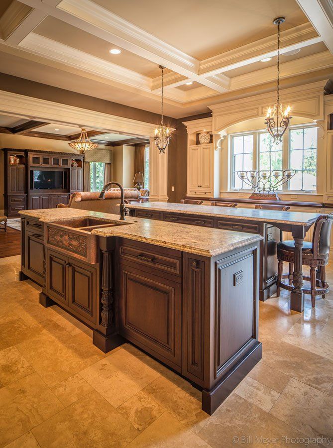 A kitchen with a large island and a sink.