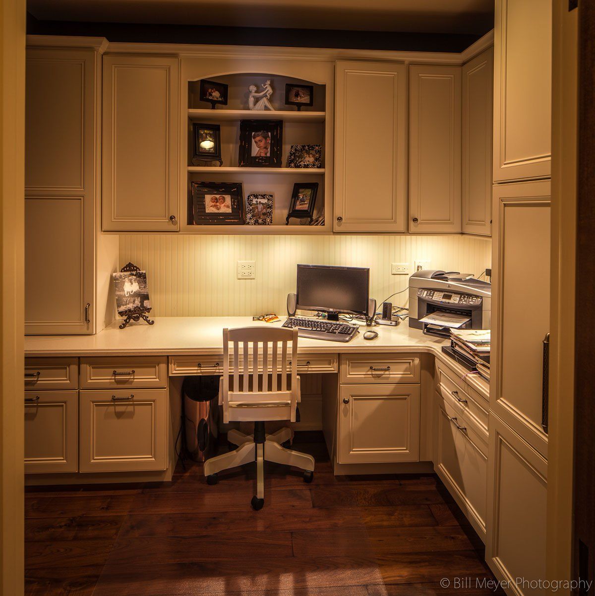A desk with a computer and a chair in a home office