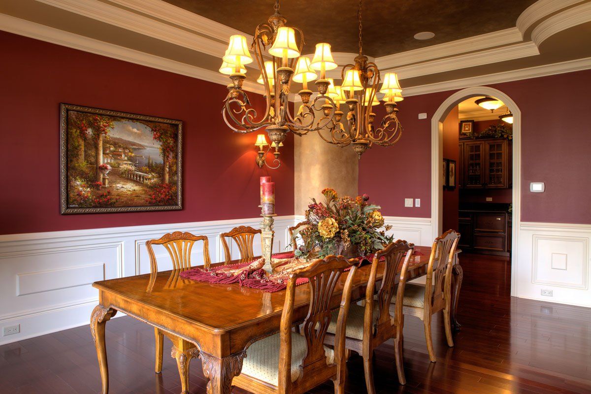 A dining room with a table and chairs and a chandelier