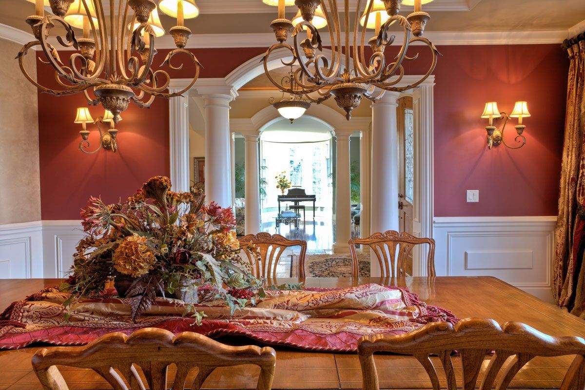 A dining room with a table and chairs and a chandelier