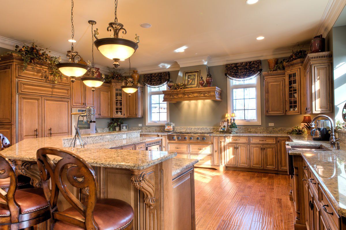 A large kitchen with wooden cabinets and granite counter tops